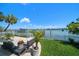 Enjoy waterfront views from the backyard's patio with well-manicured lawn at 785 Bay Esplanade, Clearwater Beach, FL 33767