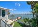 Beautiful waterfront home with fenced yard, luscious landscaping, dock, and boat lift at 785 Bay Esplanade, Clearwater Beach, FL 33767