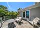 Spacious balcony with outdoor furniture, beautiful water views, and lush greenery at 785 Bay Esplanade, Clearwater Beach, FL 33767