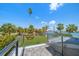 Enjoy amazing water views from this balcony, surrounded by lush tropical landscaping and blue skies at 785 Bay Esplanade, Clearwater Beach, FL 33767