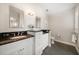 Bathroom with dual vanities, granite countertops, and custom cabinets at 785 Bay Esplanade, Clearwater Beach, FL 33767