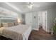 Cozy bedroom with a patterned bedspread, ceiling fan, and access to an ensuite bathroom at 785 Bay Esplanade, Clearwater Beach, FL 33767