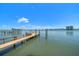Private boat dock extends into the waterfront with city views in the distance at 785 Bay Esplanade, Clearwater Beach, FL 33767