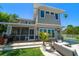 Two-story home with screened-in porch and waterfront pool and patio at 785 Bay Esplanade, Clearwater Beach, FL 33767