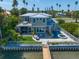 Stunning waterfront home with a metal roof, lush landscaping, and a private dock, ideal for boating enthusiasts at 785 Bay Esplanade, Clearwater Beach, FL 33767