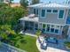 A beautiful home with a rooftop patio, screened-in porch, manicured lawn, and outdoor lounge area for stylish entertaining at 785 Bay Esplanade, Clearwater Beach, FL 33767