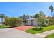 Charming home with a well-maintained lawn, brick driveway, and spacious three-car garage at 785 Bay Esplanade, Clearwater Beach, FL 33767