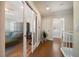Bright hallway with hardwood floors and doors leading to a room with a comfortable couch at 785 Bay Esplanade, Clearwater Beach, FL 33767