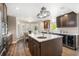 Modern kitchen featuring a large island with sink, stainless steel appliances, and wine storage at 785 Bay Esplanade, Clearwater Beach, FL 33767
