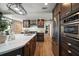 Kitchen boasting an island with sink, stainless appliances and custom cabinets at 785 Bay Esplanade, Clearwater Beach, FL 33767