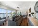 Cozy living room with water view from floor to ceiling windows, hardwood floors, and comfortable seating at 785 Bay Esplanade, Clearwater Beach, FL 33767