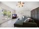 Open living room with a green couch, ceiling fan, and a view of the deck at 785 Bay Esplanade, Clearwater Beach, FL 33767