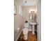 Powder room with wood floors, a pedestal sink, and neutral walls with a small window at 785 Bay Esplanade, Clearwater Beach, FL 33767