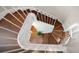 Spiral staircase showcasing wood treads, white risers, white handrail, and a decorative plant at 785 Bay Esplanade, Clearwater Beach, FL 33767