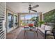 Relaxing sunroom features an outdoor view, ceiling fan, and comfortable wicker seating area at 785 Bay Esplanade, Clearwater Beach, FL 33767