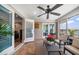 Relaxing screened lanai features water views, stylish ceiling fan, stone floors and comfortable seating at 785 Bay Esplanade, Clearwater Beach, FL 33767