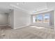 Spacious bedroom with tray ceiling, neutral carpet, and large windows providing ample natural light at 923 Seagrape Dr, Ruskin, FL 33570