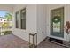 Charming entrance with a welcoming green door, brick pavers, and elegant decor at 923 Seagrape Dr, Ruskin, FL 33570