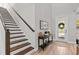 Bright foyer with hardwood floors, staircase, stylish console table, and elegant decor at 923 Seagrape Dr, Ruskin, FL 33570