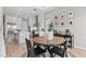 Open kitchen and dining area features modern appliances, white cabinets, and wood-style flooring at 923 Seagrape Dr, Ruskin, FL 33570