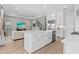 Open floor plan showcasing white kitchen, large island, stainless appliances and cozy living area at 923 Seagrape Dr, Ruskin, FL 33570