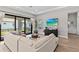 Bright living room with sliding glass doors, modern decor, and a large sectional sofa at 923 Seagrape Dr, Ruskin, FL 33570