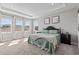 Comfortable main bedroom featuring neutral colors, tray ceiling, and plenty of natural light at 923 Seagrape Dr, Ruskin, FL 33570
