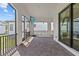 Covered patio with brick flooring, arched openings, a mounted TV, and views of the backyard at 923 Seagrape Dr, Ruskin, FL 33570