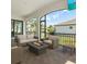 Covered outdoor patio with comfortable seating and a cozy fire pit overlooking the backyard at 923 Seagrape Dr, Ruskin, FL 33570