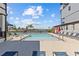Community pool featuring lounge chairs, poolside shade, landscaping, and marina views at 923 Seagrape Dr, Ruskin, FL 33570