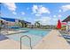 Community pool featuring lounge chairs, poolside shade, landscaping, and marina views at 923 Seagrape Dr, Ruskin, FL 33570
