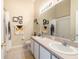Well-lit bathroom featuring double sinks, stylish decor, and tile flooring at 9807 Carlsdale Dr, Riverview, FL 33578