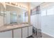 Bright bathroom with double sinks, a large mirror, and a shower-tub combination at 9807 Carlsdale Dr, Riverview, FL 33578