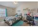 Bright bedroom featuring a cozy bed and a dedicated study area at 9807 Carlsdale Dr, Riverview, FL 33578