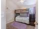 Cozy bedroom featuring a wooden bunk bed and a purple rug on the carpeted floor, next to the window at 9807 Carlsdale Dr, Riverview, FL 33578