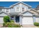 Charming two-story townhome featuring a one-car garage, blue exterior, and well-maintained landscaping at 9807 Carlsdale Dr, Riverview, FL 33578
