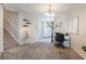 Inviting foyer with staircase, decorative lighting, and a tiled entrance, adjacent to a home office at 9807 Carlsdale Dr, Riverview, FL 33578