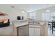 Kitchen with stainless steel dishwasher with a view of an eat-in dining area at 9807 Carlsdale Dr, Riverview, FL 33578