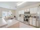 Bright kitchen with stainless steel appliances, ample counter space, and white cabinetry at 9807 Carlsdale Dr, Riverview, FL 33578