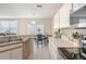 Well-lit kitchen with white cabinets and eat-in dining area at 9807 Carlsdale Dr, Riverview, FL 33578