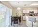 Bright kitchen featuring a dining area with a sliding glass door and modern appliances at 9807 Carlsdale Dr, Riverview, FL 33578