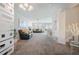 Bright, open-concept living room with comfortable seating and neutral tones throughout at 9807 Carlsdale Dr, Riverview, FL 33578