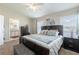 Comfortable main bedroom with a full-sized bed and ensuite bathroom at 9807 Carlsdale Dr, Riverview, FL 33578