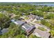 An aerial view of a neighborhood, showcasing cozy homes, verdant trees, and a tranquil waterfront setting at 11467 93Rd St, Largo, FL 33773