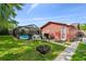 Beautiful backyard with screened pool, patio area, fire pit, and lush greenery; perfect for outdoor entertaining at 11467 93Rd St, Largo, FL 33773
