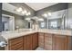 Bathroom featuring a large mirror, cabinets, light fixtures, and a view of the walk-in shower at 11467 93Rd St, Largo, FL 33773