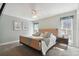 Light-filled bedroom with carpet, nautical wall art, and large windows with decorative curtains at 11467 93Rd St, Largo, FL 33773