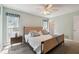 Light-filled bedroom with carpet, a large window, nautical wall art, and a ceiling fan at 11467 93Rd St, Largo, FL 33773