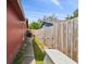 Side of the house featuring a walkway, landscaping, and fencing for added privacy at 11467 93Rd St, Largo, FL 33773