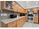 Kitchen featuring wooden cabinets, countertops, and stainless steel appliances at 11467 93Rd St, Largo, FL 33773